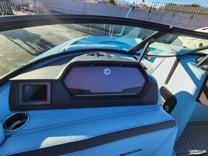 Slide: The Image of 2023 MasterCraft XStar S interior with blue upholstery and sleek dashboard design. - 14