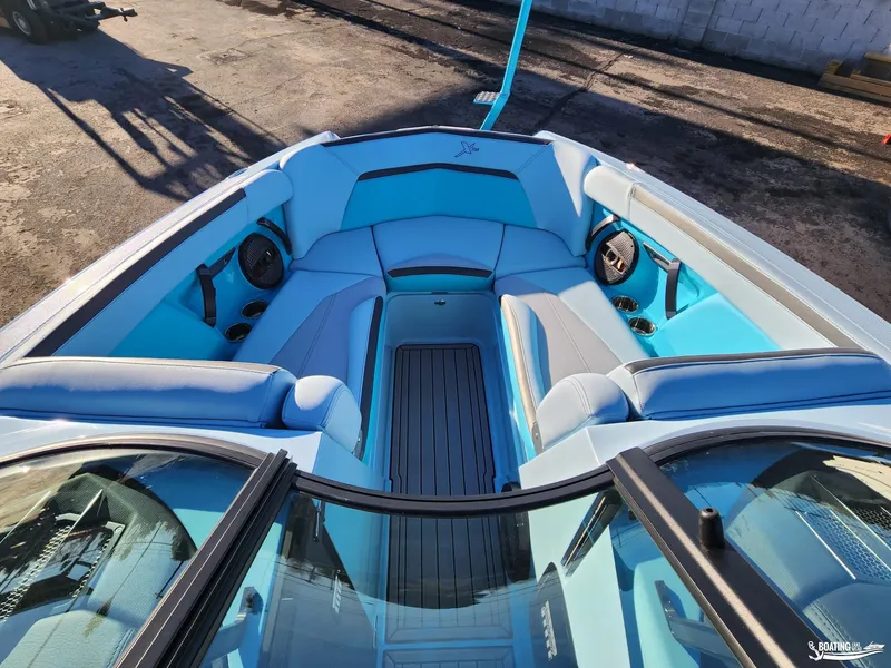 Slide: The Image of 2023 MasterCraft XStar S boat interior with blue seating and speakers. - 15