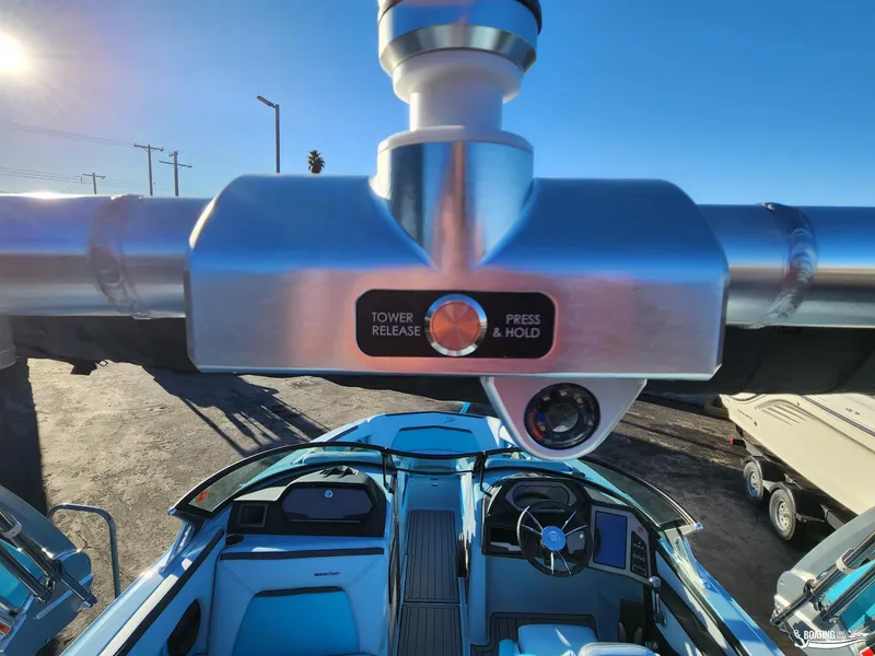 Slide: The Image of 2023 MasterCraft XStar S boat interior with tower release button, sunny day. - 17