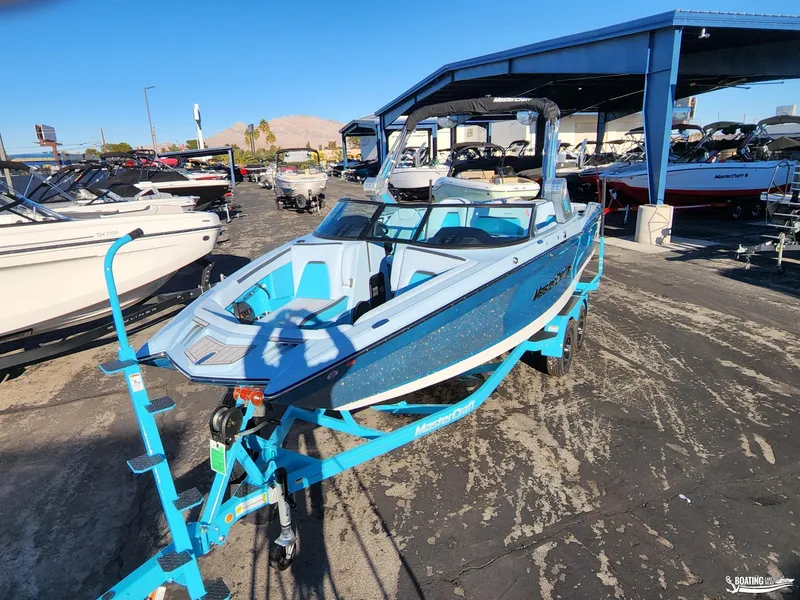 Slide: The Image of 2023 MasterCraft XStar S boat on trailer in outdoor showroom. - 2