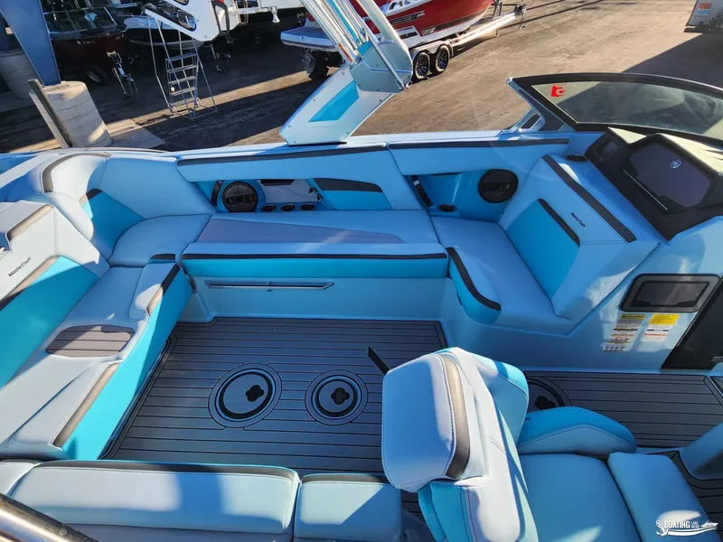 Slide: The Image of 2023 MasterCraft XStar S interior with blue seating and modern dashboard. - 6