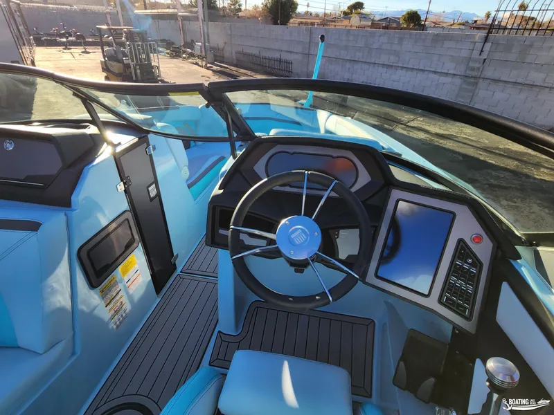 Slide: The Image of 2023 MasterCraft XStar S boat interior with modern dashboard and steering wheel. - 7
