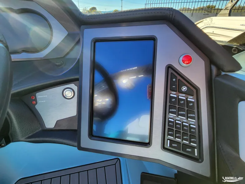 Slide: The Image of 2023 MasterCraft XStar S dashboard with touchscreen and control panel. - 9