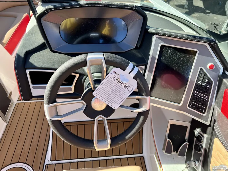 Slide: The Image of 2023 MasterCraft X24 boat dashboard with steering wheel and control panel. - 3