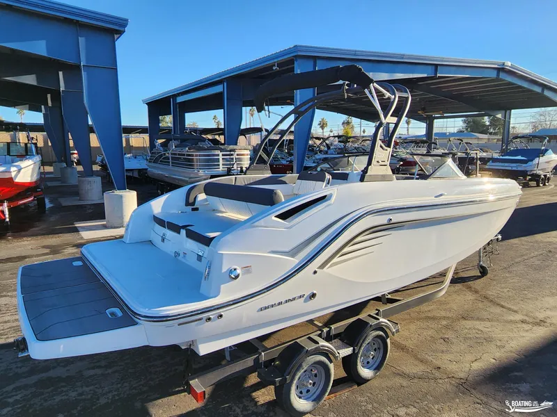 Slide: The Image of 2023 Bayliner DX2250 boat on trailer in marina setting. - 3