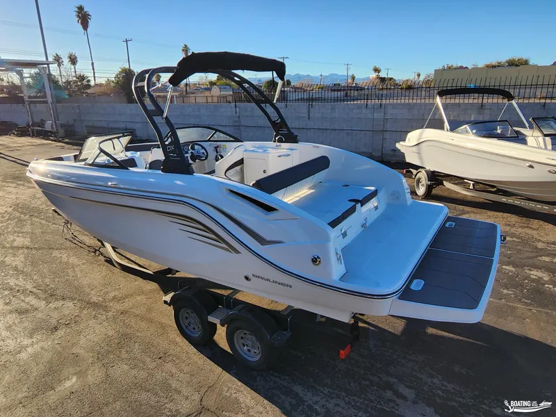 Slide: The Image of 2023 Bayliner DX2250 boat on trailer, sleek design, outdoor setting. - 5
