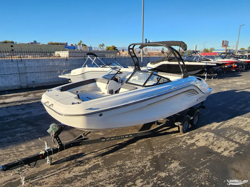 Slide: The Image of 2023 Bayliner DX2250 boat on trailer in outdoor showroom. - 6