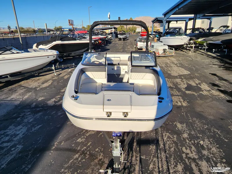 Slide: The Image of 2023 Bayliner DX2250 boat displayed in a marina, surrounded by other boats. - 7
