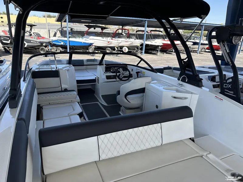 Slide: The Image of 2023 Bayliner DX2250 boat interior with seating and steering wheel. - 9
