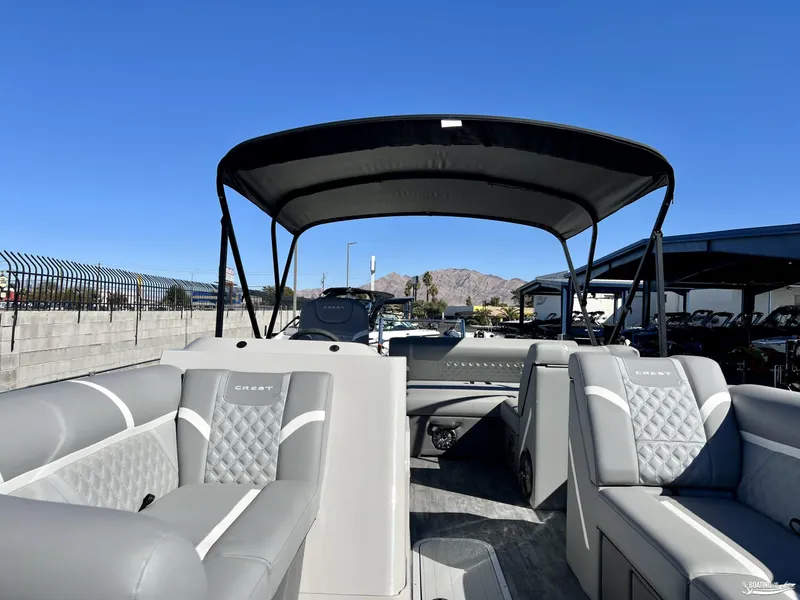 Slide: The Image of 2023 Crest Classic Platinum 220 SLS pontoon boat with luxurious seating and canopy. - 3