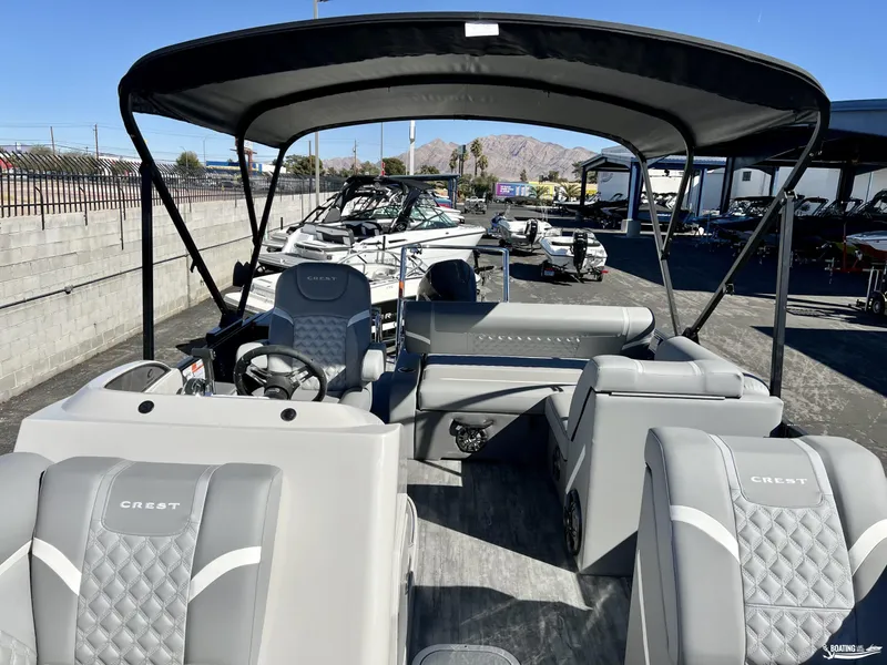 Slide: The Image of 2023 Crest Classic Platinum 220 SLS pontoon boat with elegant seating and canopy. - 4