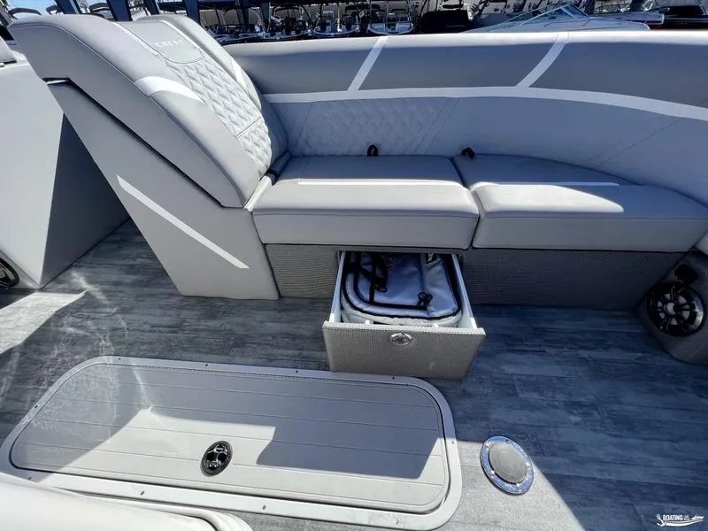 Slide: The Image of 2023 Crest Classic Platinum 220 SLS boat interior with storage compartment open. - 5