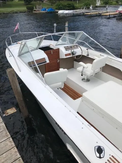 Slide: The Image of 1972 Chris-Craft Lancer boat docked on a lake. - 10