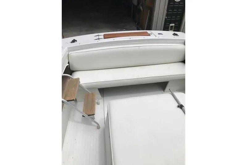 Slide: The Image of 1972 Chris-Craft Launch 23 boat interior with white seating and wooden steps. - 12