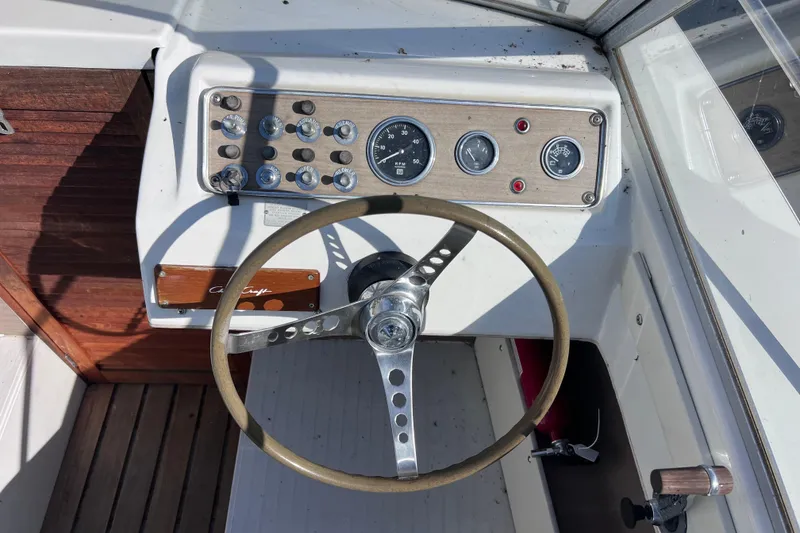 Slide: The Image of 1972 Chris-Craft Launch 23 boat dashboard with steering wheel and gauges. - 15