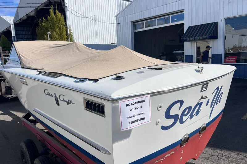 Slide: The Image of 1972 Chris-Craft Launch 23 boat with cover, parked outside a building. - 2