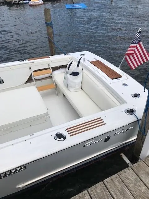 Slide: The Image of 1972 Chris-Craft Lancer boat docked with American flag. - 7
