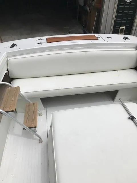Slide: The Image of 1972 Chris-Craft Lancer boat interior with white seating and wooden steps. - 8