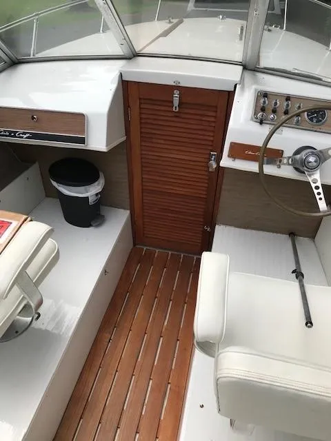 Slide: The Image of 1972 Chris-Craft Lancer boat interior with wooden flooring and white seating. - 9