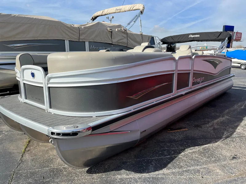 Slide: The Image of 2022 Premier 250 Solaris RF pontoon boat in a marina. - 10
