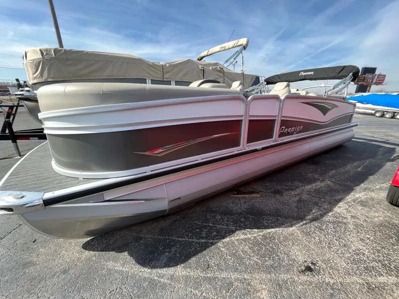 Slide: The Image of 2022 Premier 250 Solaris RF pontoon boat in a parking lot. - 11