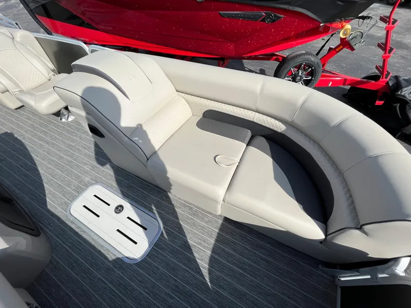 Slide: The Image of 2022 Premier 250 Solaris RF boat interior with beige seating and gray flooring. - 16
