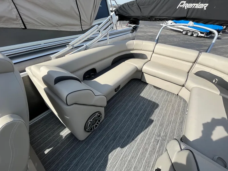 Slide: The Image of 2022 Premier 250 Solaris RF boat interior with beige seating and gray flooring. - 20