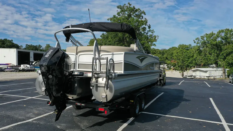 Slide: The Image of 2022 Premier 250 Solaris RF pontoon boat on a trailer in a parking lot. - 4