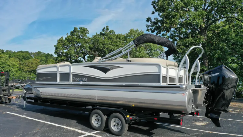 Slide: The Image of 2022 Premier 250 Solaris RF pontoon boat on a trailer in a parking lot. - 5