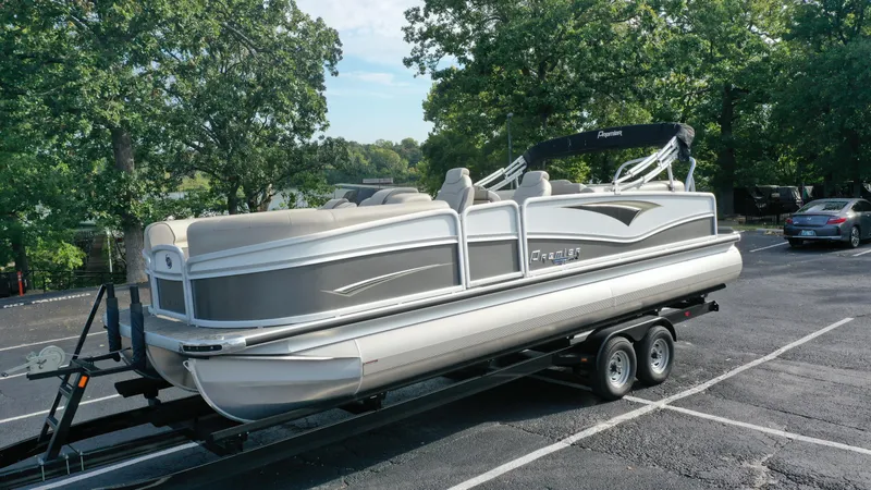 Slide: The Image of 2022 Premier 250 Solaris RF pontoon boat on a trailer in a parking lot. - 9