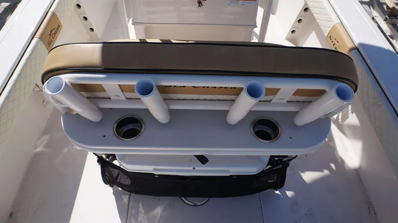 Slide: The Image of 2023 Sea Chaser 23 LX boat interior with rod holders and cushioned seating. - 11