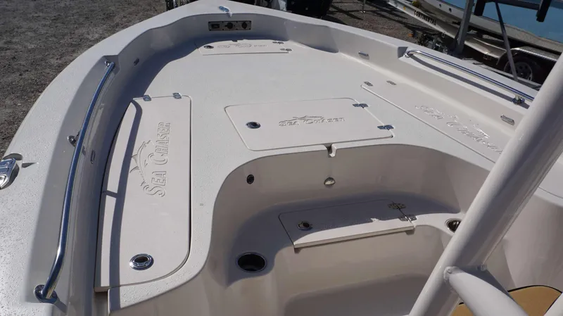 Slide: The Image of 2023 Sea Chaser 23 LX boat deck with storage compartments and stainless steel railings. - 15