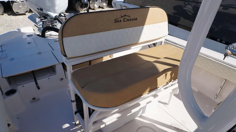 Slide: The Image of 2023 Sea Chaser 23 LX boat with tan and white cushioned seating. - 18