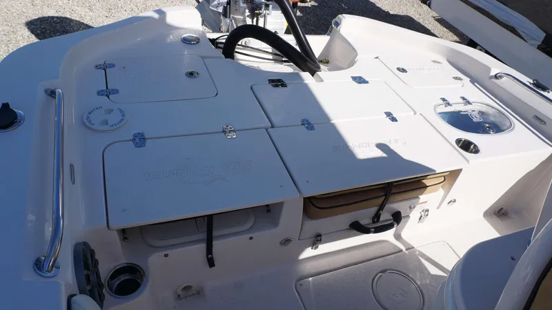 Slide: The Image of 2023 Sea Chaser 23 LX boat deck with storage compartments and fresh water access. - 19