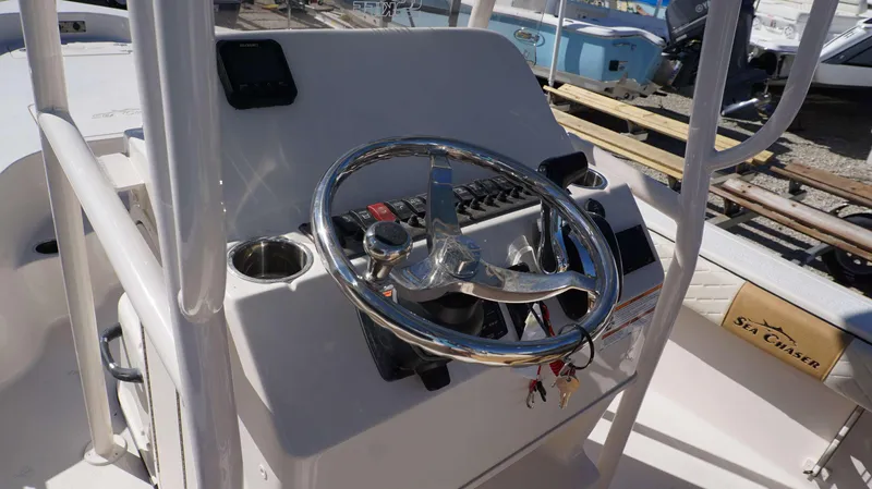 Slide: The Image of 2023 Sea Chaser 23 LX boat console with steering wheel and control panel. - 4