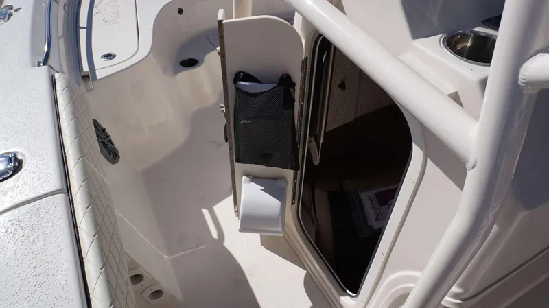 Slide: The Image of 2023 Sea Chaser 23 LX boat interior with storage compartment and seating. - 8