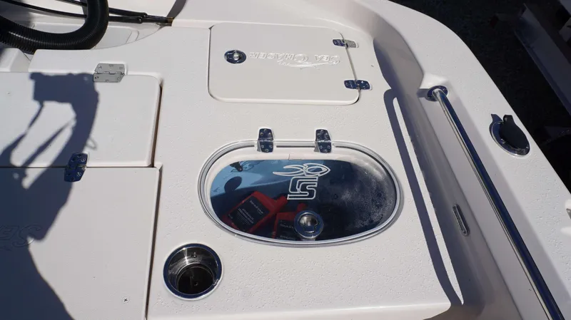 Slide: The Image of 2023 Sea Chaser 23 LX boat deck with storage compartments and livewell. - 9