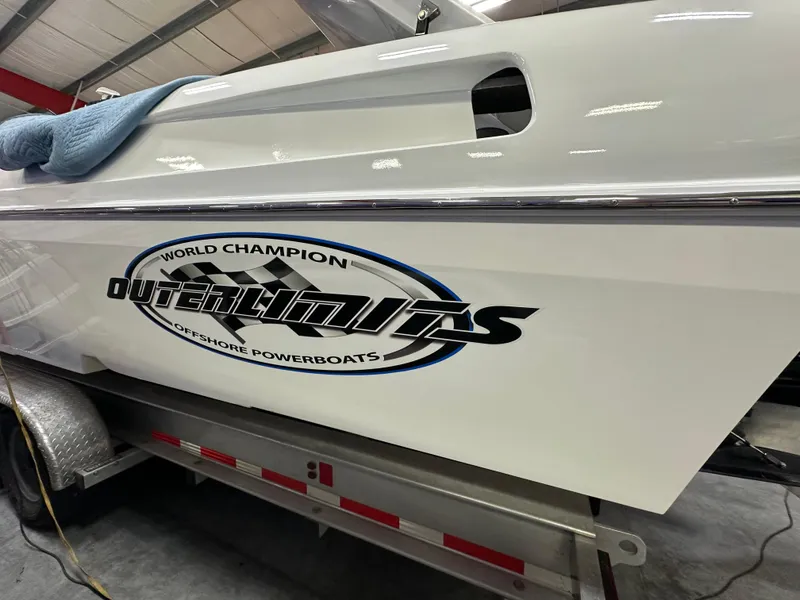 Slide: The Image of 2003 Outerlimits 47 GTX powerboat on trailer, showcasing sleek design and branding. - 17