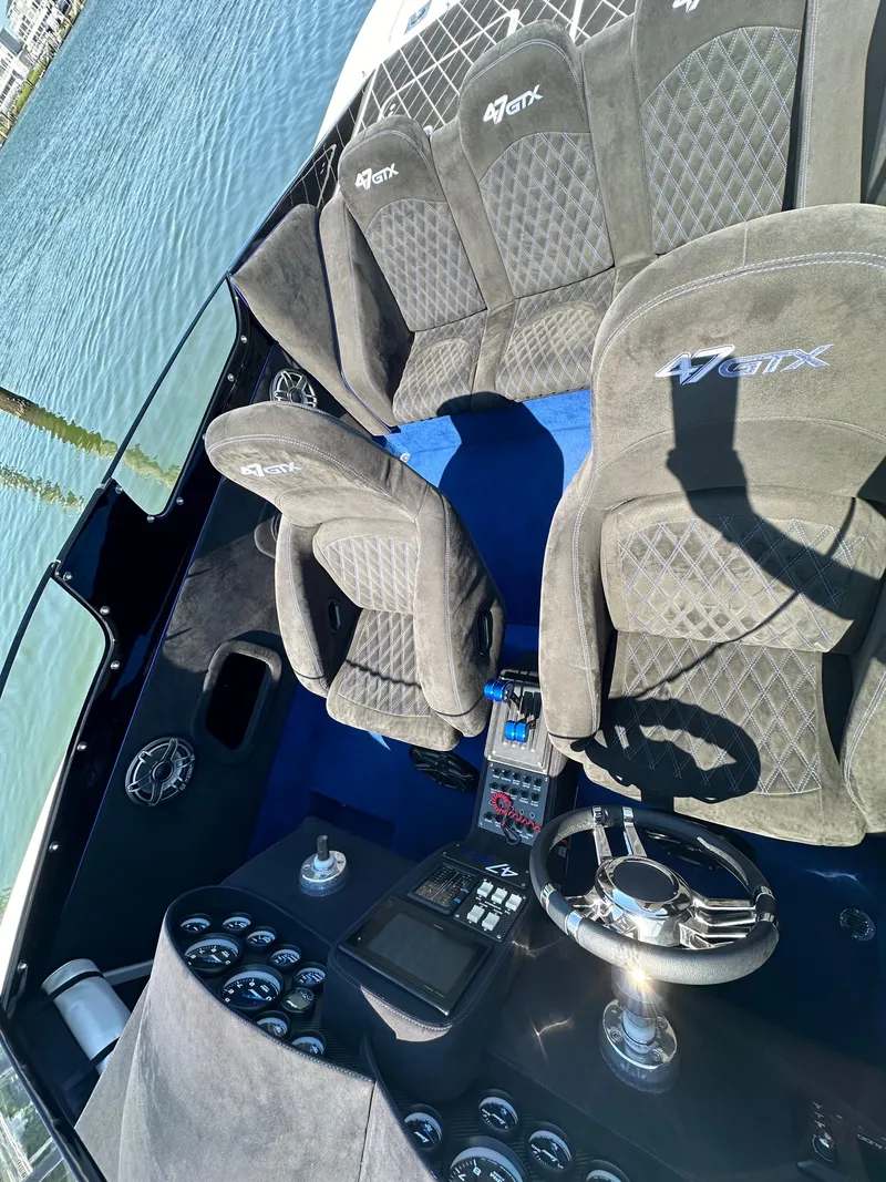 Slide: The Image of 2003 Outerlimits 47 GTX cockpit with plush seating and modern controls. - 22