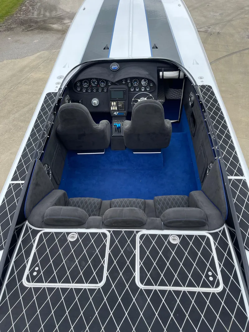 Slide: The Image of 2003 Outerlimits 47 GTX boat interior with black diamond pattern and blue carpet. - 23