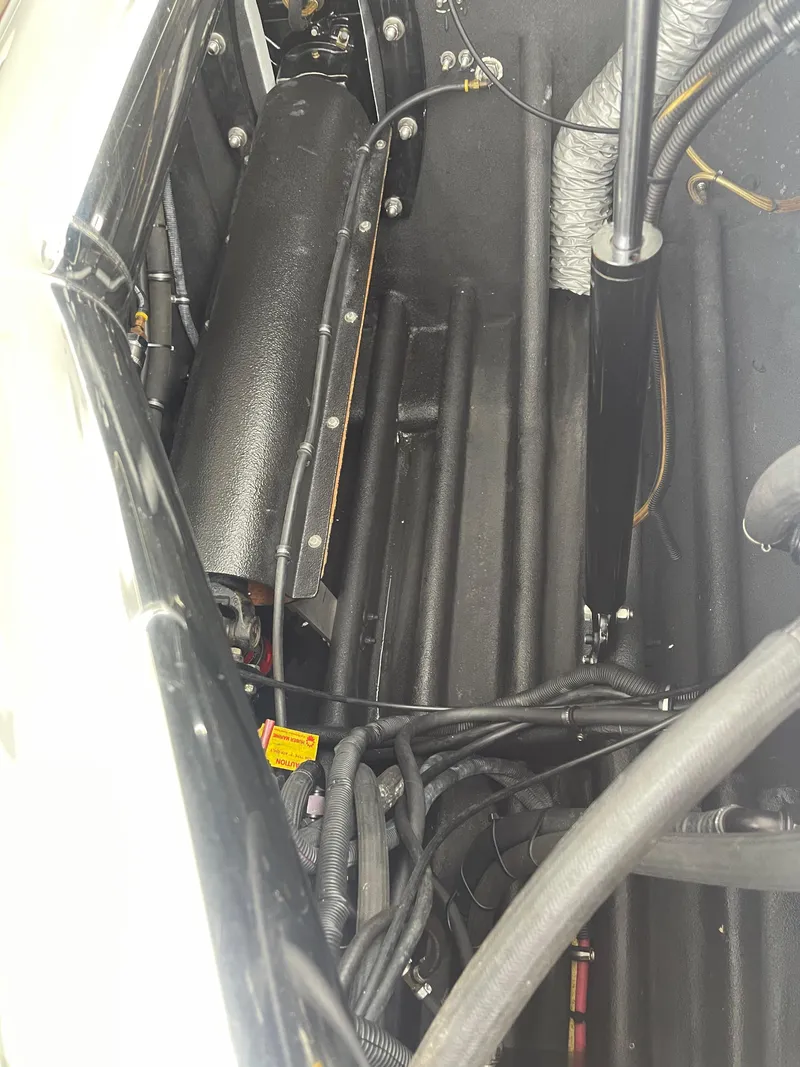 Slide: The Image of Engine compartment of 2003 Outerlimits 47 GTX boat, showing mechanical components and wiring. - 25