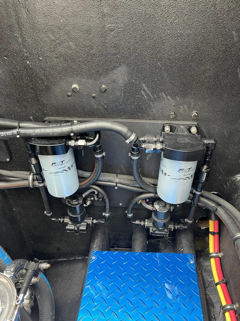 Slide: The Image of Engine compartment of 2003 Outerlimits 47 GTX with fuel filters and blue diamond plate flooring. - 31