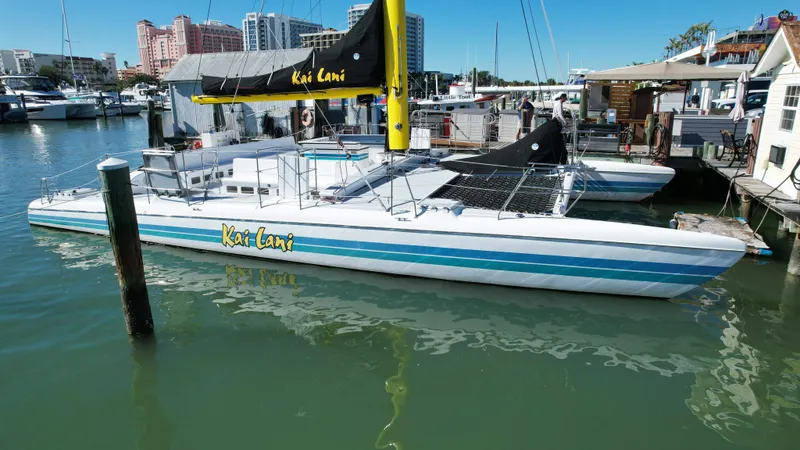 Slide: The Image of 1992 Robertson Custom Catamaran Sloop Rig Kai Lani docked in a marina. - 12