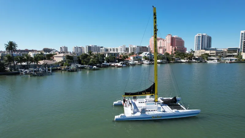 Slide: The Image of 1992 Robertson Custom Catamaran Sloop Rig sailing near waterfront cityscape. - 17