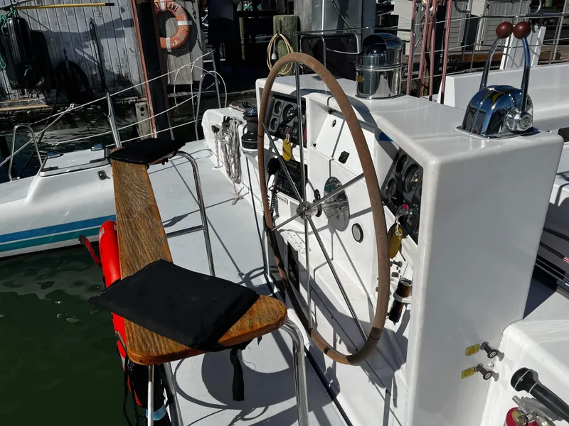 Slide: The Image of Cockpit of 1992 Robertson Custom Catamaran Sloop Rig with wooden helm and control panel. - 22