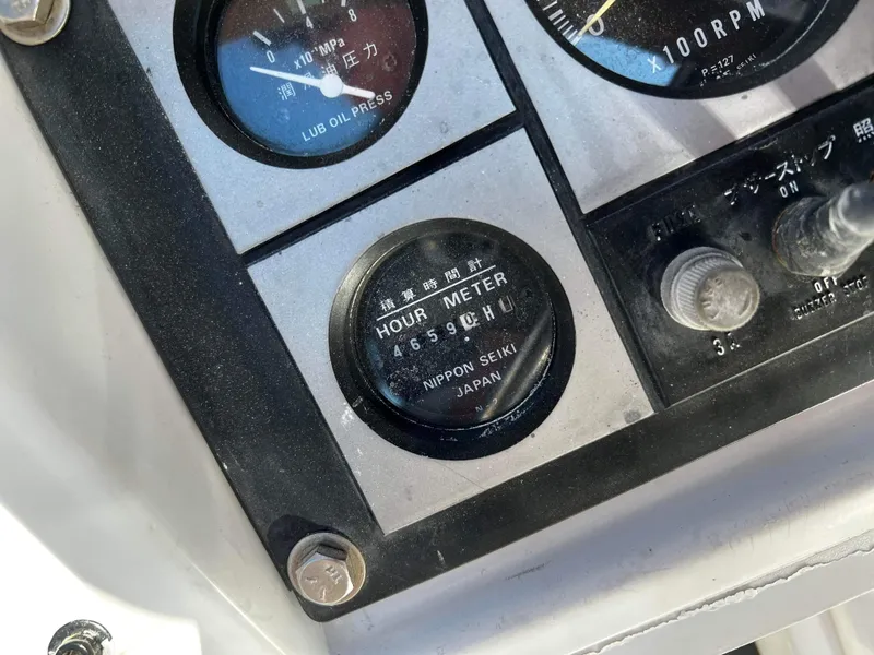 Slide: The Image of Hour meter and gauges on a 1992 Robertson Custom Catamaran / Sloop Rig. - 24