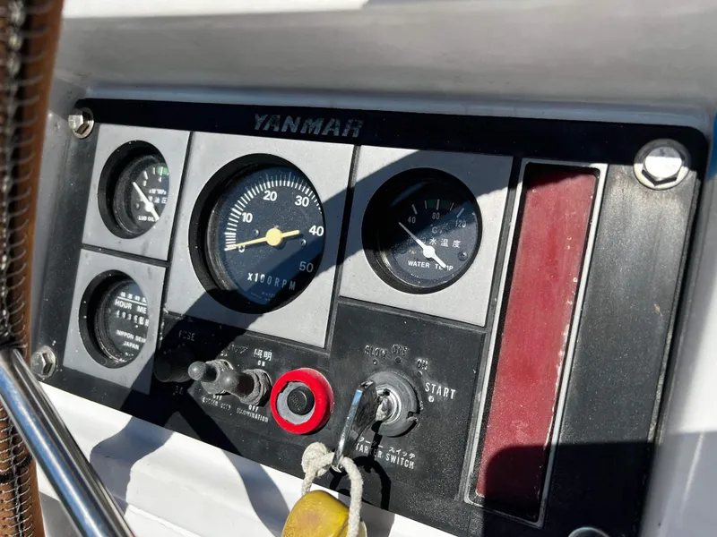 Slide: The Image of Control panel of a 1992 Robertson Custom Catamaran with Yanmar engine gauges. - 27