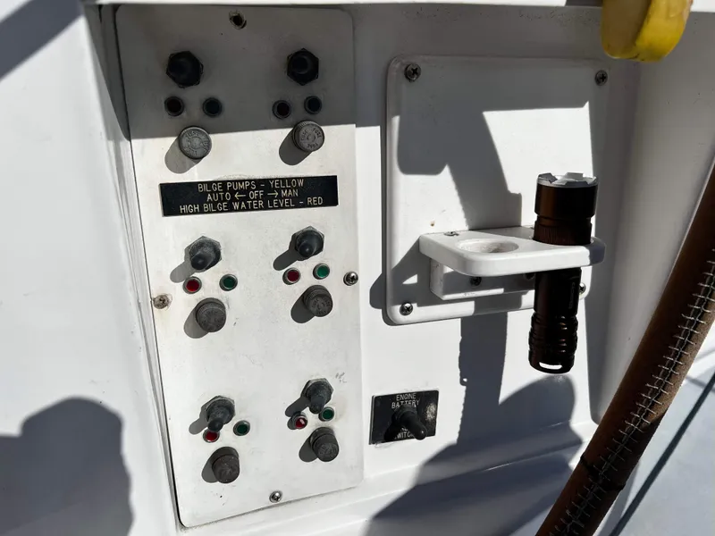 Slide: The Image of Control panel of a 1992 Robertson Custom Catamaran/Sloop Rig with bilge pump switches. - 29