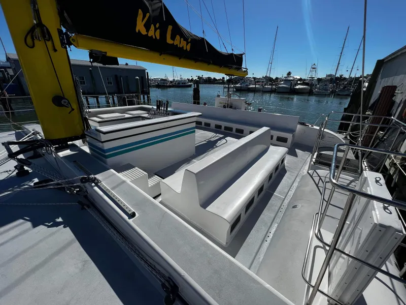 Slide: The Image of 1992 Robertson Custom Catamaran Sloop Rig with seating and docked at marina. - 31
