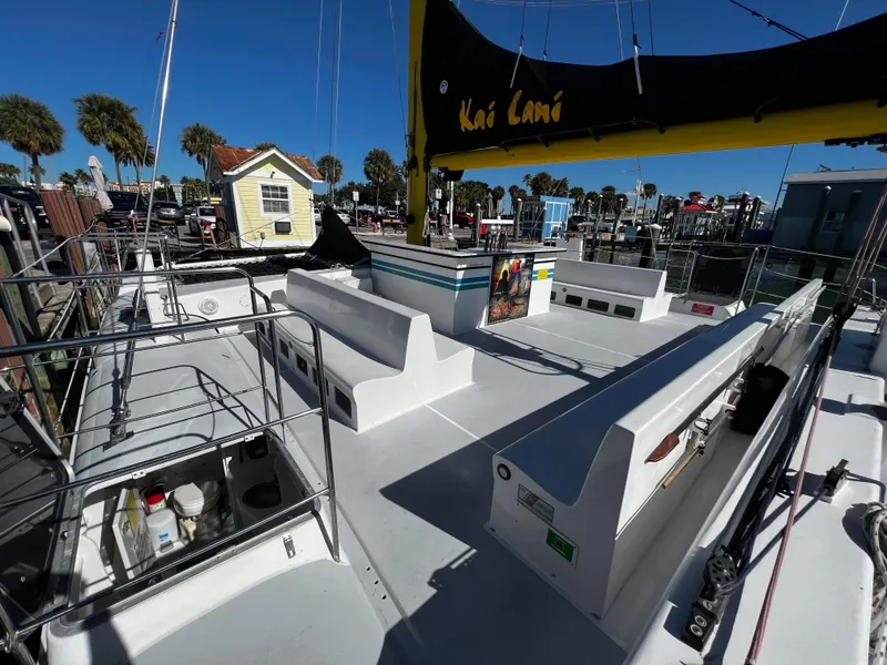 Slide: The Image of 1992 Robertson Custom Catamaran Sloop Rig deck with seating and storage, docked at marina. - 33